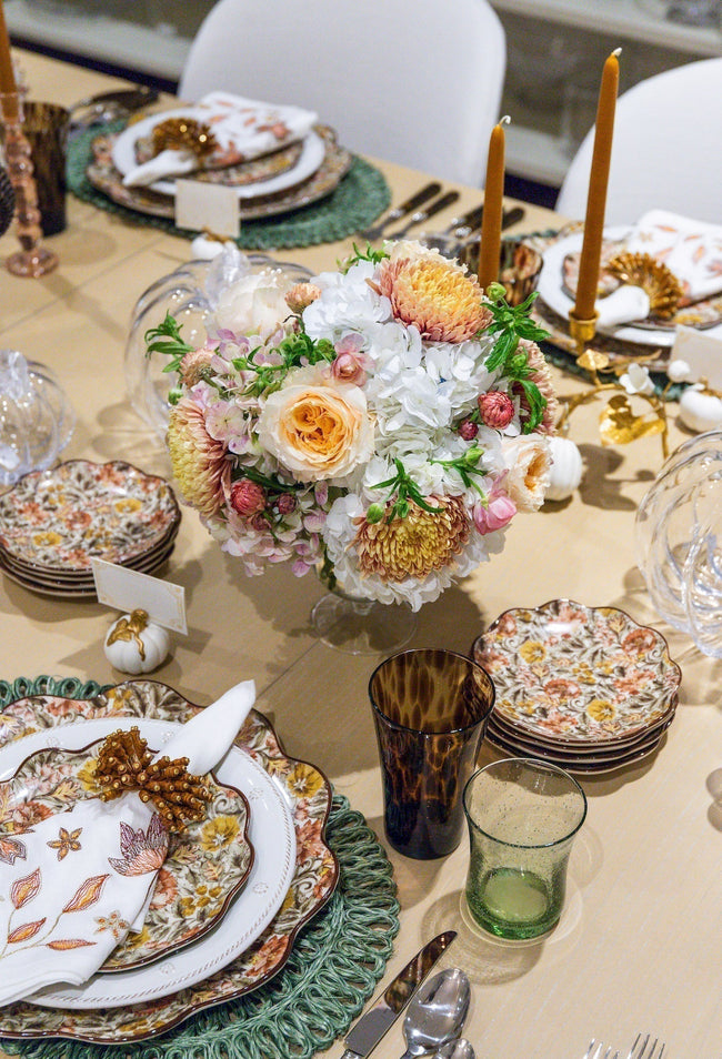 fall table setting with floral arrangement at center