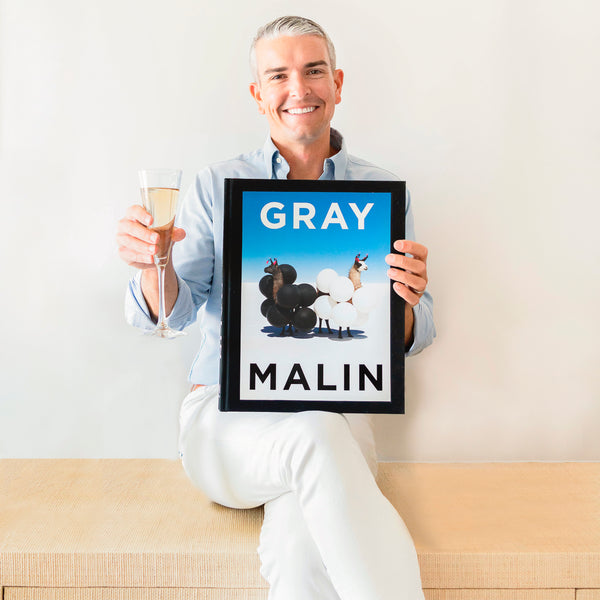 Gray Malin holding book