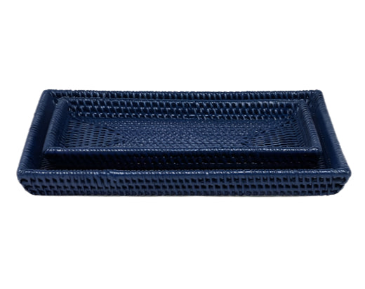 The Dalton Bath Collection by Pigeon & Poodle features two nested rectangular navy blue trays, each handcrafted from rattan with detailed craftsmanship—the smaller tray fits neatly inside the larger one.