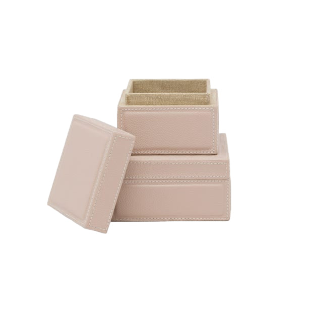 The Asby Desk Accessory Collection by Pigeon & Poodle features two light pink full-grain leather boxes, one open and one with the lid beside it—ideal for organizing desk essentials or keepsakes.