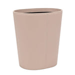 The Asby Desk Accessory Collection by Pigeon & Poodle features a beige, oval-shaped waste bin in full-grain leather with visible stitching—an elegant upgrade for your workspace.