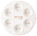 The Berry & Thread Classic Whitewash Seder Plate by Juliska showcases a fluted ceramic design with six Hebrew-labeled sections for traditional symbolic foods.