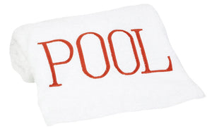 The Hamburg House Pool Towel in dark orange is folded on a white background with "POOL" in bold red letters—a stylish poolside accessory.