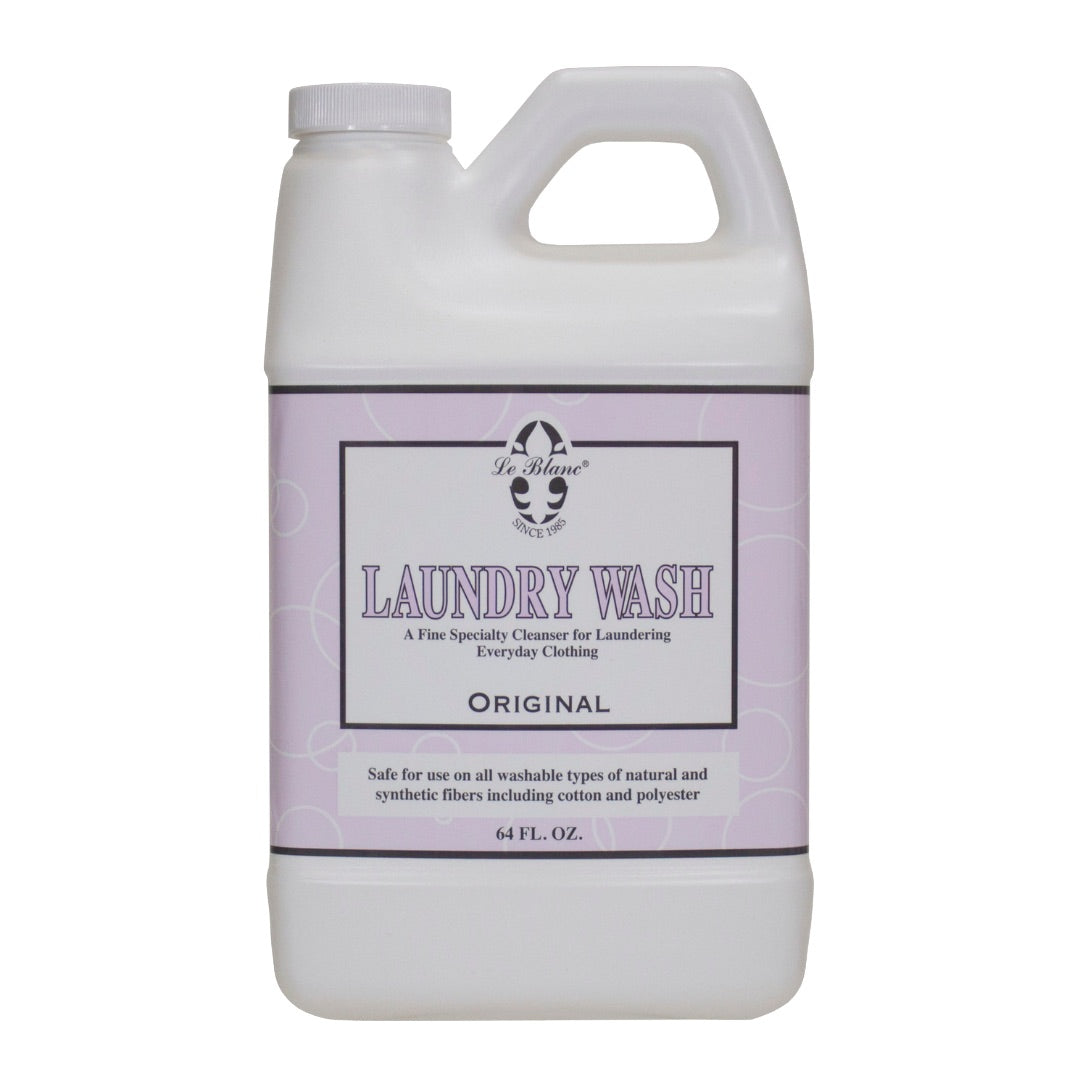 A 64 fl. oz. white bottle of Le Blanc Laundry Wash, a specialty cleanser with a refreshing scent, designed for laundering everyday clothing in cold water.