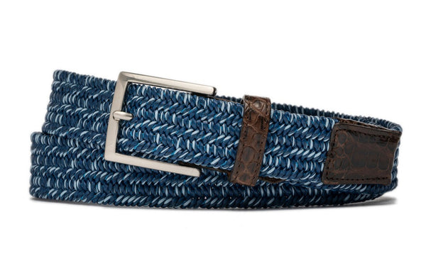 Sentence with replaced product and brand name: W. Kleinberg Men's Solid Stretch Belt with Croc Tabs is a woven blue belt with a silver buckle and brown leather accents.