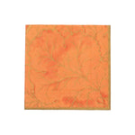 Gilded Majolica Coral Collection orange paper napkin by Caspari, featuring an embossed decorative leaf and vine pattern, offers stylish disposable tableware for any occasion. Set against a white background.