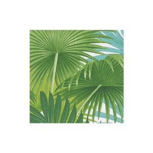 The Caspari Palm Fronds White Collection features overlapping green palm leaves on a white background with touches of blue sky, creating an eco-friendly look.