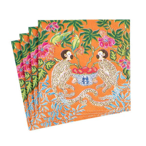 The Caspari Monkeys Orange napkins feature two monkeys by a bowl of fruit, surrounded by flowers and green foliage. Set includes four triple-ply orange napkins.