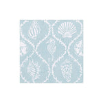 The Seychelles Aqua Collection napkin by Caspari features a light blue square triple-ply design with white outlines of seashells, sand dollars, and a seahorse in a repeating pattern.