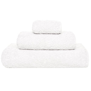 Three Grand Egoist Bath Collection towels by Graciozza, made from premium Sea Island Cotton, are folded and stacked in ascending size order against a plain white background.