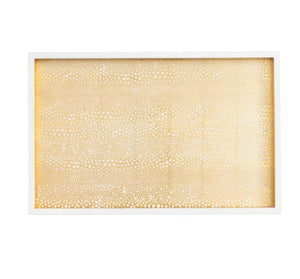 The Caspari Pebble Gold Lacquer Vanity Tray is a rectangular piece handmade in Vietnam, featuring a white border and a gold dotted pattern for a timeless accent.