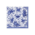The Delft Blue Collection by Caspari features a white square napkin with a blue floral pattern and border, crafted from eco-friendly, biodegradable triple-ply material for both elegance and sustainability.