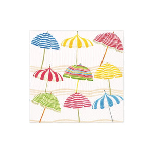 The Beach Umbrella Collection by Caspari features colorful striped umbrellas on a light, wavy background, capturing summer’s cheerful vibe—ideal for eco-friendly, biodegradable triple-ply napkins.
