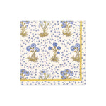 The Caspari Semis de Fleurs Blue Collection napkin features blue and yellow flowers with green stems, a yellow and blue floral border, and is crafted from eco-friendly, FSC-certified materials.