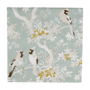 The Caspari Scenic Songbirds Collection features eco-friendly square paper napkins with three birds perched on leafy branches against a light green background.