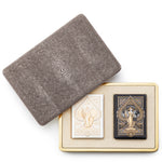 The Aerin Chocolate Shagreen Card Set features a textured case with a suede-lined beige tray holding two decorative decks—one white and gold, the other black and gold—partially displayed with the lid removed.