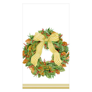 The Caspari Magnolia Wreath Collection features a decorative wreath with green leaves, red berries, and a yellow striped bow on white with gold stripes—perfect for triple-ply biodegradable napkins.