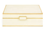 The Aerin Large Shagreen Jewelry Box features a cream embossed shagreen texture, elegant brass trim, and a central gold handle on the front.