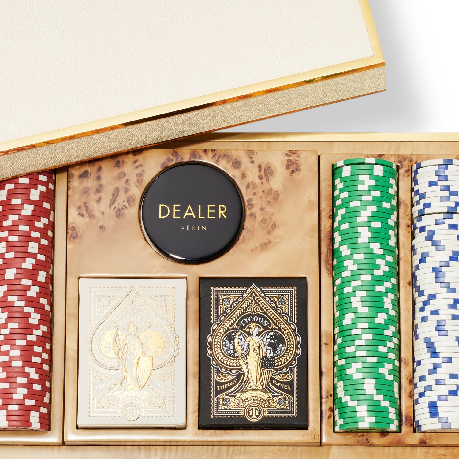 The Aerin Shagreen Poker Set in Cream features red, green, blue, and white chips, two card decks, and a dealer button elegantly arranged in a luxurious beige shagreen case with wood accents.