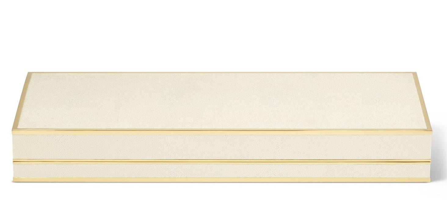 The Aerin Shagreen Poker Set in cream features a rectangular box with gold trim and a smooth, flat lid, shown closed against a white background.