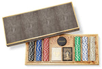 The Aerin Shagreen Poker Set in Chocolate features a textured shagreen case, colorful poker chips, two decks of cards, and a sleek black dealer chip.