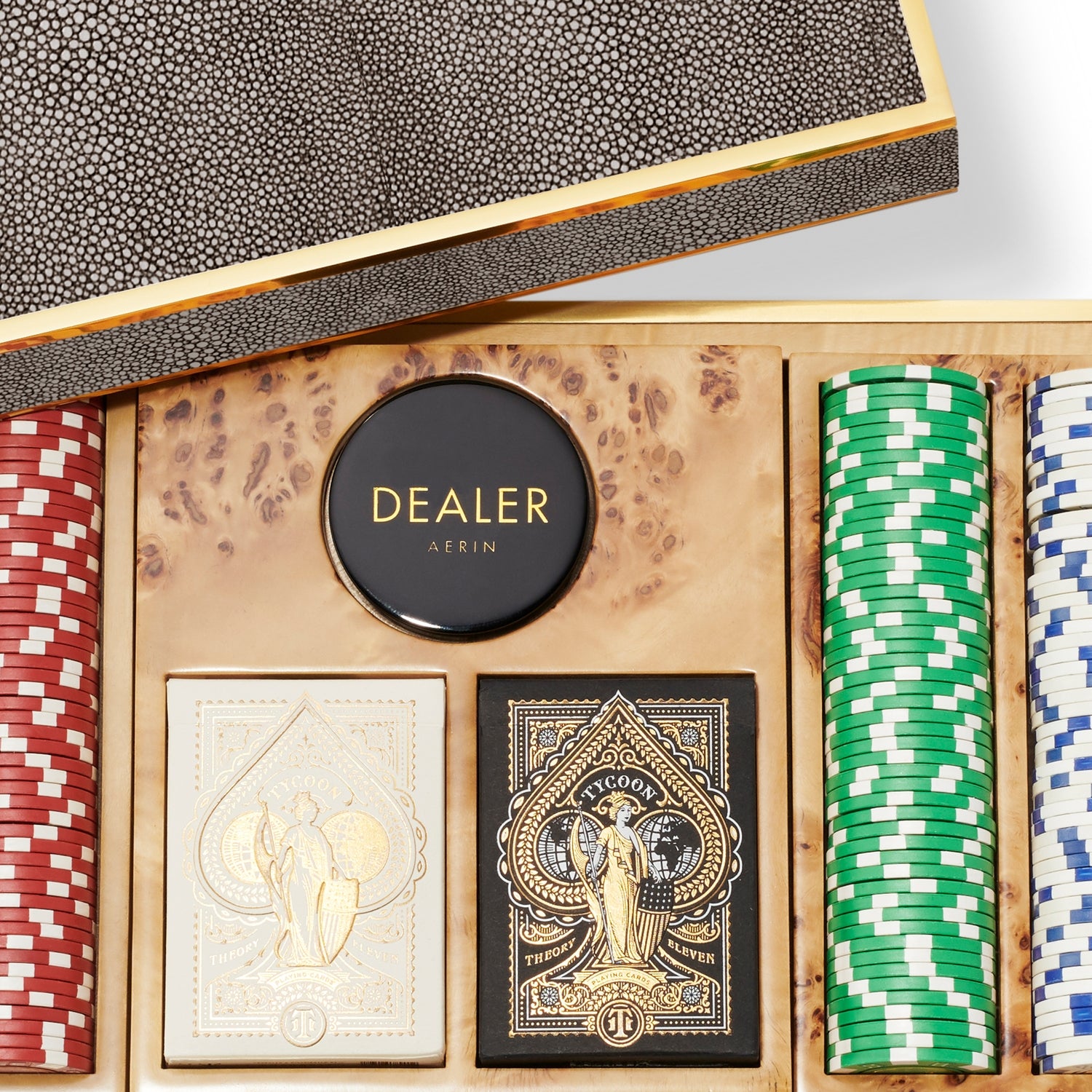 The Aerin Shagreen Poker Set, Chocolate, features multicolored chips, two card decks, and a dealer marker, all stylishly housed in an elegant chocolate shagreen wooden case with a textured lid.