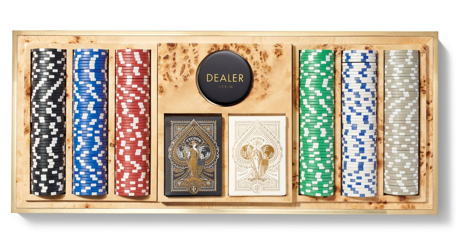The Aerin Shagreen Poker Set in Chocolate features organized stacks of colorful chips, two ornate card decks, and a dealer button—perfect for game night.