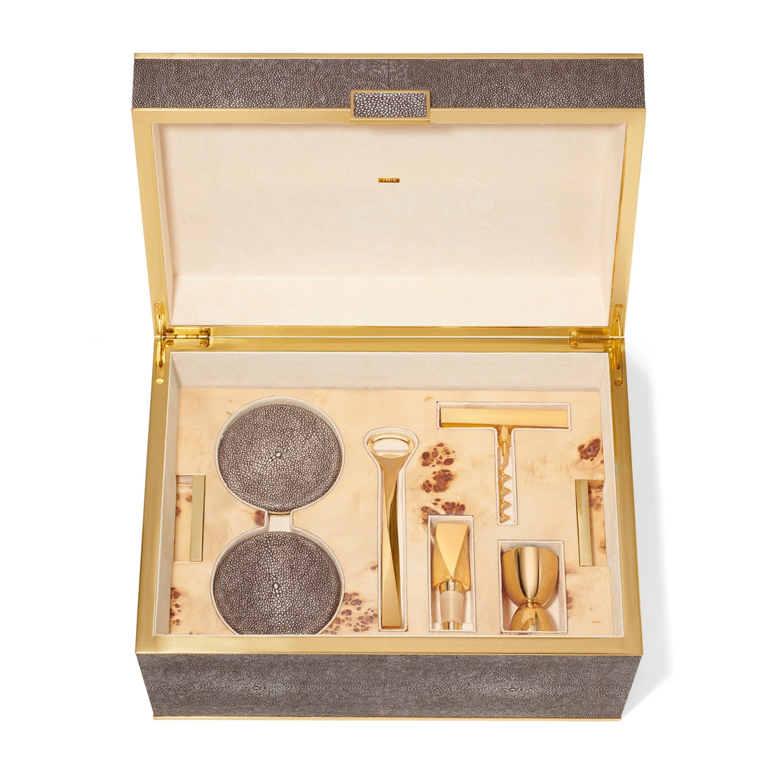 The Aerin Chocolate Classic Shagreen Bar Set features a textured box in rich brown and gold, with a velvet-lined interior holding a corkscrew, jigger, bottle opener, strainer, and stopper for an elegant home bar experience.