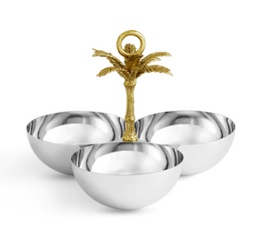 The Michael Aram Palm Triple Bowl features three joined silver bowls, a central gold palm tree handle, sculpted textures from the Palm Collection, and an elegant antique gold finish.