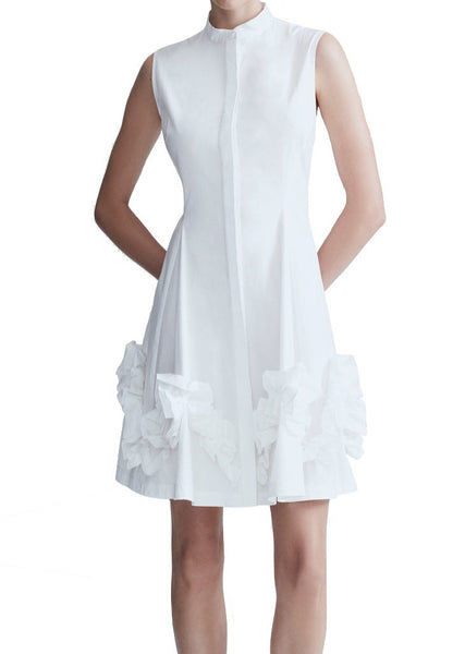 A sleeveless Lela Rose Natalie Dress in white cotton with ruffled detailing on the skirt.