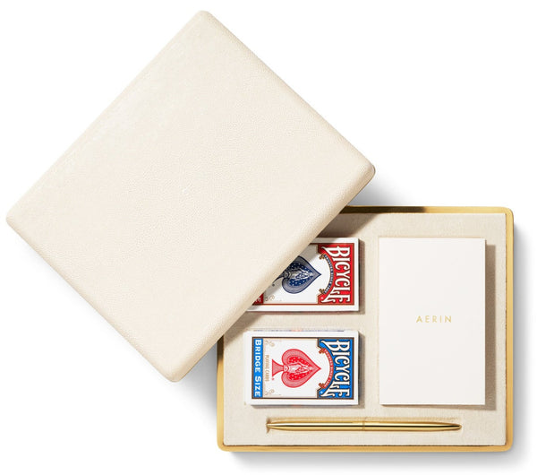 A white box with a pen and AERIN Shagreen Bridge Set, Cream inside.