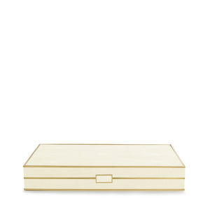 The Aerin Shagreen Backgammon Set in cream features a rectangular box with a shagreen finish, gold trim, and clasp—an elegant accessory perfect for elevating any luxurious board game collection.