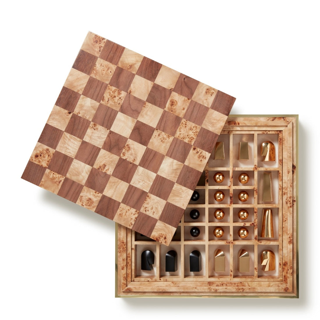 The Colette Cane Chess Set by Aerin features a wooden chessboard that lifts to reveal a storage compartment with gold-plated chess pieces in individual slots—a striking addition to any collection.