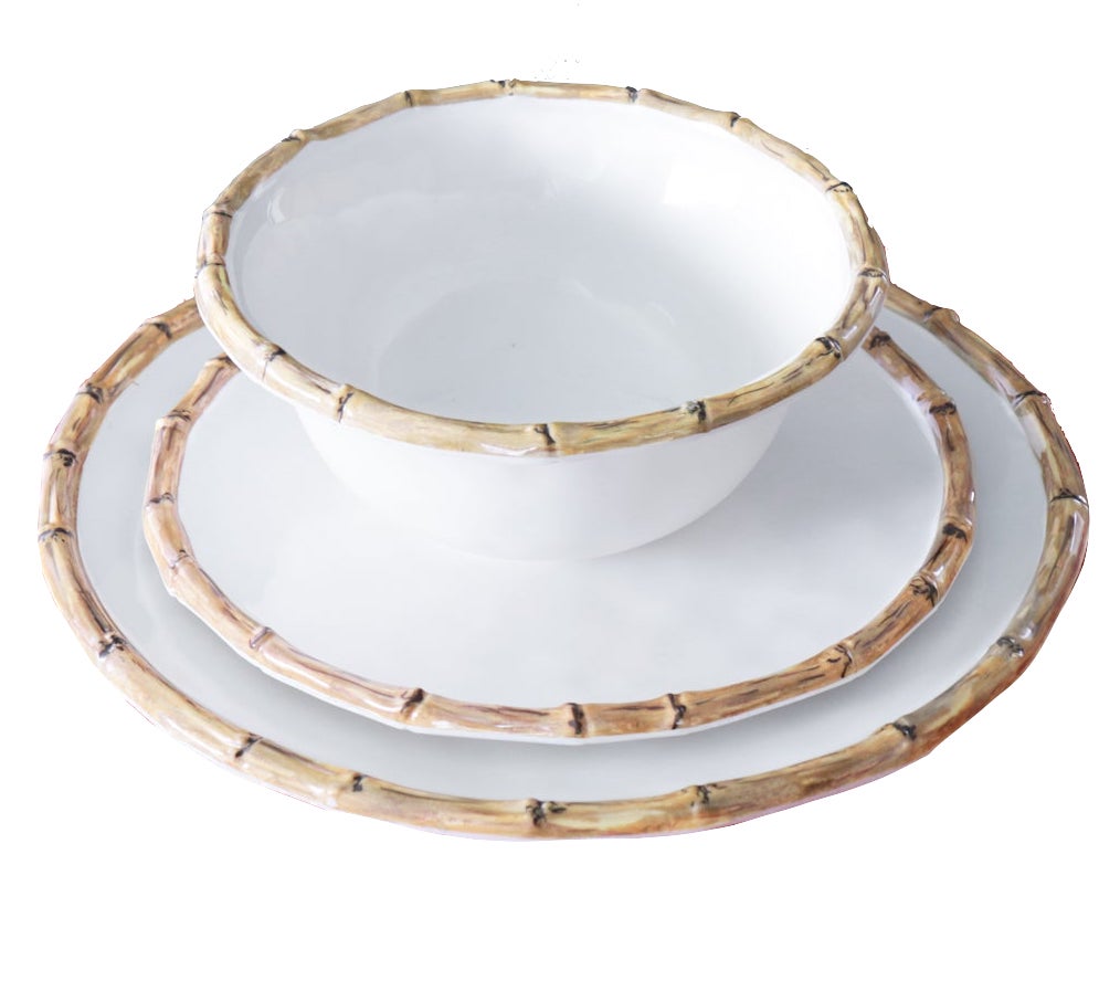 A white bowl and two stacked white plates with bamboo-style rims are shown on a white background. The Beatriz Ball Vida Natural Bamboo Dinnerware Collection is crafted from luxury melamine for style and break resistance.