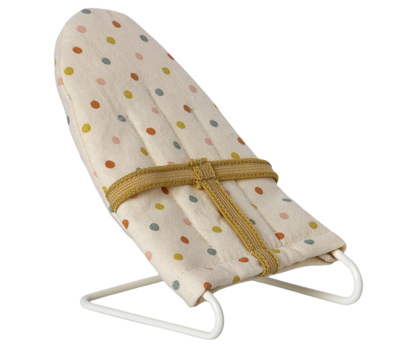 A polka-dotted Maileg Babysitter, Micro fabric-covered baby bouncer on a white background.