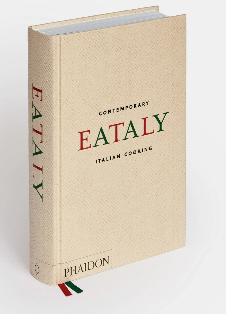 The cookbook "Eataly: Contemporary Italian Cooking" by Phaidon showcases a cover with a textured beige backdrop, highlighted by red and green details that capture the spirit of traditional Italian home cooking.