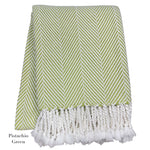 The Nantucket Herringbone Throw Collection by A Soft Idea features a pistachio green and white chevron design in soft cotton, finished with hand-knotted fringe tassels.