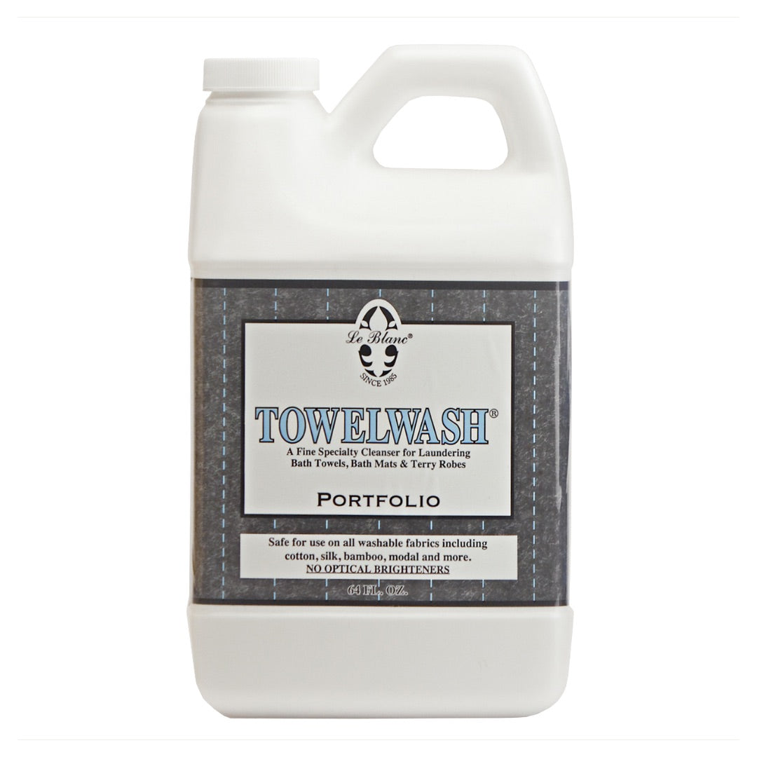 A white plastic bottle of Le Blanc Towel Wash with a handle and label indicating it is designed for laundering absorbent towels and washable fabrics.