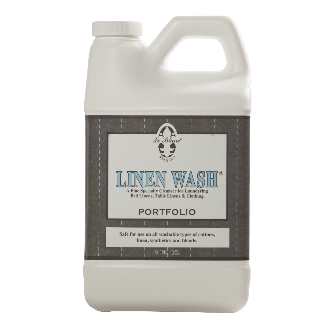 A plastic bottle of Le Blanc Linen Wash, a specialty cleanser designed for laundering luxury bed linens, table linens, and clothing with an effective cold water formula.