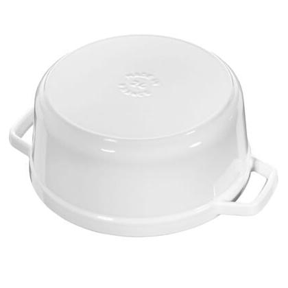 The Staub Cast Iron Dutch Oven Collection features a white dish with two handles, seen here upside down, ideal for slow-cooking meals.