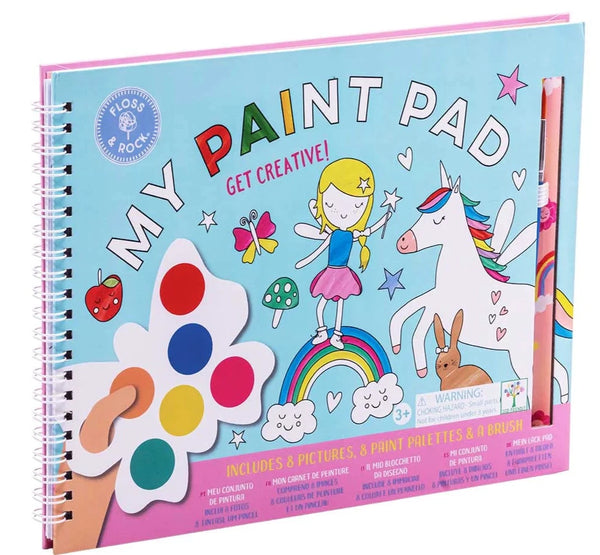 Colorful children's spiral bound Floss and Rock Rainbow Fairy My Painting Pad book featuring a girl, unicorns, and rainbow designs, with art tools visible on the cover.