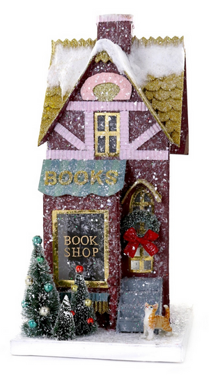 The Cody Foster Book Shop is a miniature snow-covered shop with a BOOKS sign, Christmas trees, a wreath on the door, and a cat figurine. Made of sturdy cardboard with charming details, it's perfect for festive packaging or display.