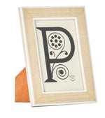 A framed monogram of the letter 'p' with decorative elements on a stand, crafted from Pigeon & Poodle Aberdeen Frame Collection and Narra veneer wood.