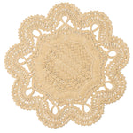The Belladonna Placemat by Blue Pheasant is a round, beige crocheted piece featuring scalloped edges and intricate lacy patterns—ideal for adding elegance to your table setting.