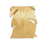 The Neela Napkin Ring Set by Blue Pheasant features wide gold brass rings with a detailed feather design, ideal for anyone who loves unique, feather-shaped statement napkin rings.