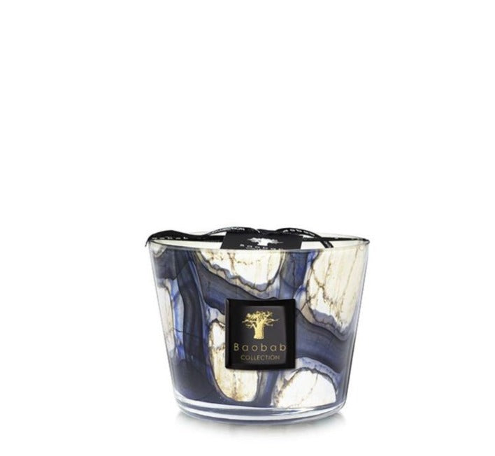 A scented Baobab Collection Stones Lazuli Candle in a decorative glass holder with a marbled blue and white design reminiscent of Lazuli Stones.