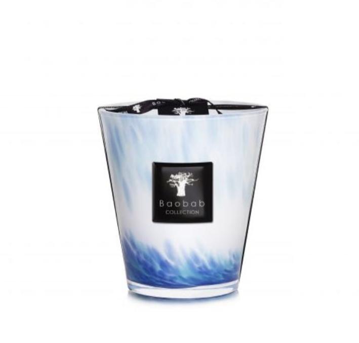 The Baobab Collection Eden Seaside Candle, housed in a stylish blue and white holder with the "Baobab" label on the front, fills your space with enchanting notes of amber and vetiver.