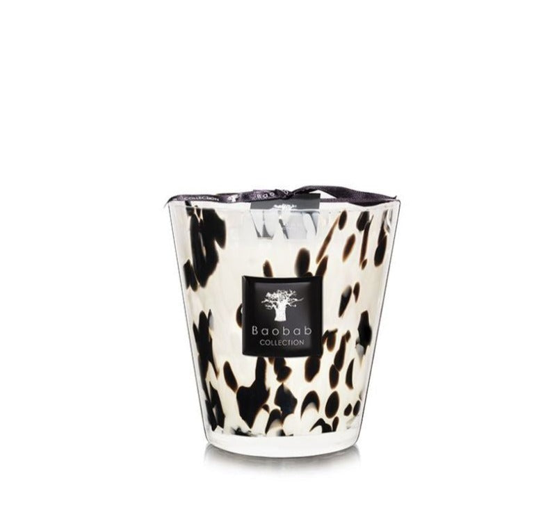 A Baobab Collection Pearls Black Candle in a hand-blown glass holder with a black and white animal print design, isolated on a white background.