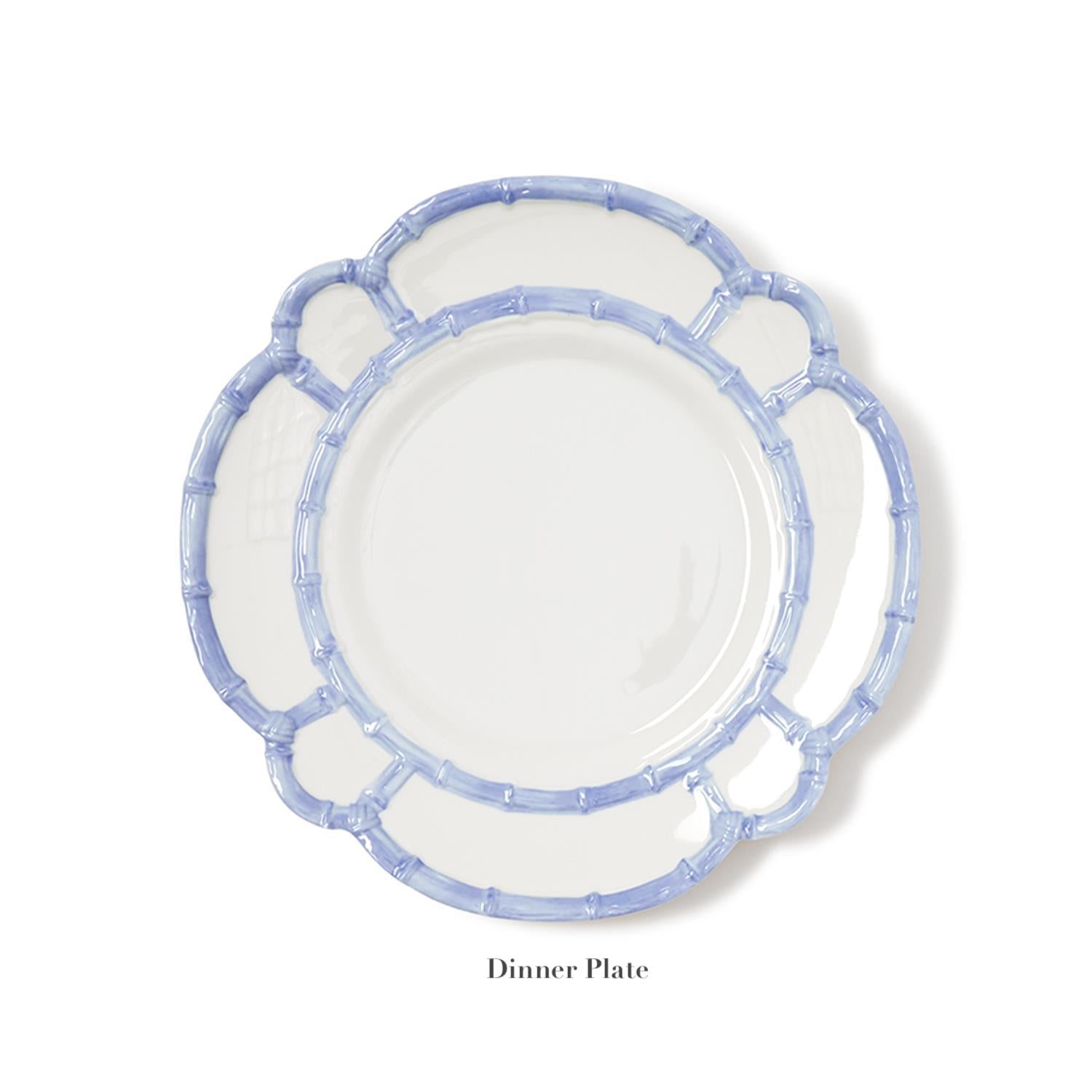 A white dinner plate with a scalloped edge and blue bamboo-style border from the Melamine Bamboo Dinnerware Collection by Two's Company is displayed on a plain white background. The label "Dinner Plate" appears beneath.