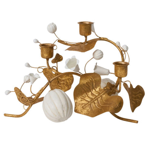 The Forest Walk Tabletop Collection by Juliska features a gold metal candle holder with leaf and stem design, white artificial flowers, and a white gourd-like ornament—an elegant addition to your decor.